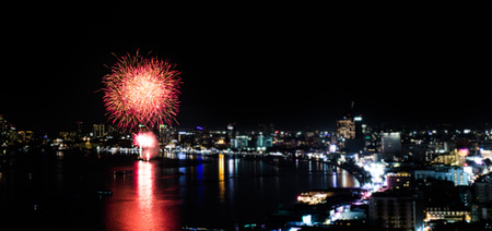 PATTAYA - NOVEMBER 28: The colorful firework and skyscrapers at Pattaya bay during Pattaya International Fireworks Festival 2014 on November 28,2014 in Pattaya,Thailand.のeditorial素材