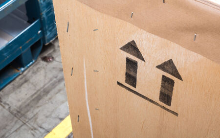 arrow up icon on wooden board in the warehouseの写真素材