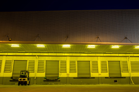 Warehouse with yellow lights at nightの写真素材