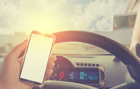 Using cellphone in car - with defocused city traffic.