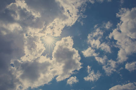 Cloudy blue sky and sunの写真素材