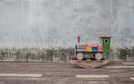 Wooden toy train on old cement backgroundの写真素材