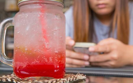 cherry italian soda drink on girls phone
