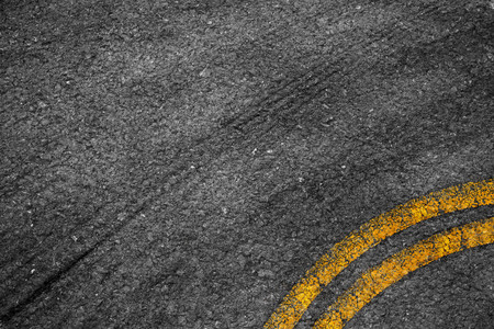 Asphalt background texture with some fine grain with Yellow Stripe