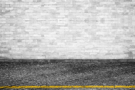Background of old vintage White brick wall on roadの写真素材