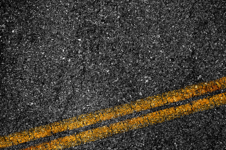 Asphalt background texture with some fine grain with Yellow Stripeの写真素材