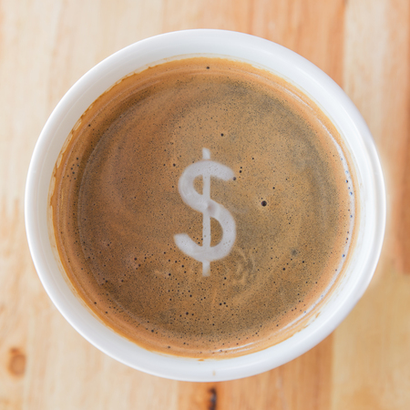 Heart in cup of coffee with in a white cup on wooden background.の写真素材