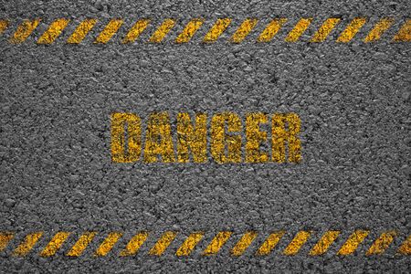 Danger asphalt background texture with some fine grain with Yellow Stripe