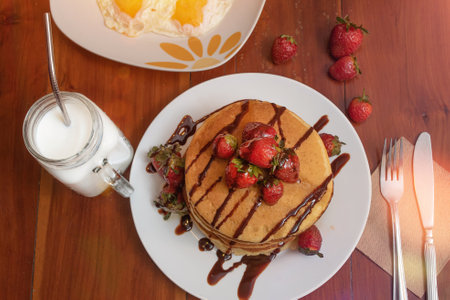 Closeup of hot cakes and strawberries on a table