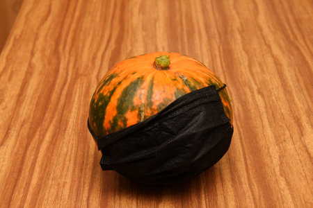 pumpkin in a medical mask, Halloween and virus, holidays during the pandemicの写真素材
