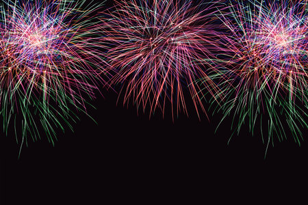 Colorful firework on the night sky. New Year celebration fireworks. Abstract firework isolated on black background with free space for textの写真素材