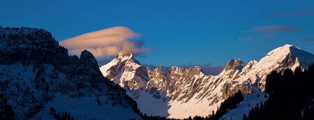 Colored sky at sunset sunset in snowy mountains. Flaine, Grand Massif, France