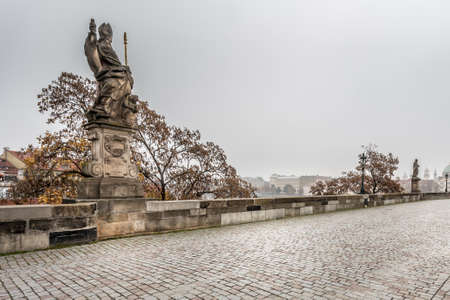 Autumn dawn in historic Prague at Charles Bridge over the Vltava River. Prague, ENESCO monument, Czech Republicの写真素材