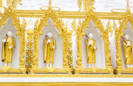 Four monks at white wall of templeの写真素材