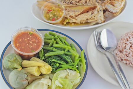 Chilli sauce, fried mackerel, boiled vegetable and rice from the market in Bangkok, Thailandの写真素材