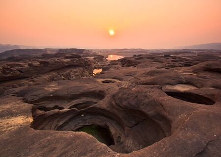 sunset rock holes  stone View Sam-Pan-Bok Grand Canyon in thailand の写真素材