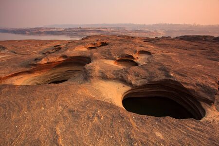 sunset rock holes  stone View Sam-Pan-Bok Grand Canyon in thailand の写真素材