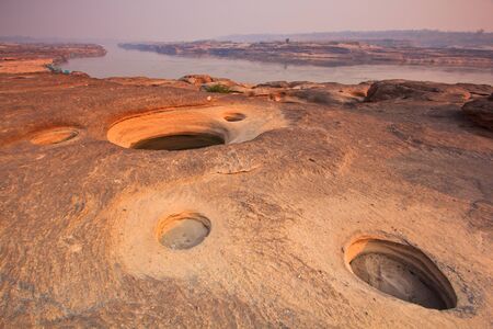 sunset rock holes  stone View Sam-Pan-Bok Grand Canyon in thailand の写真素材