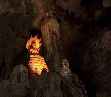Old  buddha in cave thailandの写真素材