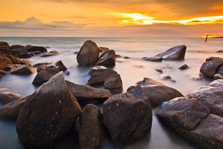Rocks, sea, sunset on the Tropical sea beach の写真素材