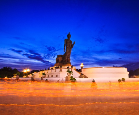 Buddha statue candle lit in lent day thailand and Walk with lighted candles in hand around a templeの写真素材