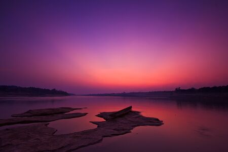 Silhouettes landscape view sunset and old wooden boats in mekong river ubon ratchathani province thailand の写真素材