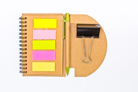 spiral notebook and pen and paperclip 