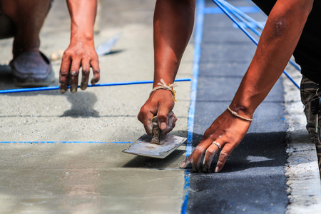 plasterer concrete worker smooth the cementの写真素材