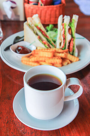 Tea in glass cup and sandwich french friesの写真素材