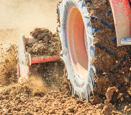 Tractor plows a field shoveling