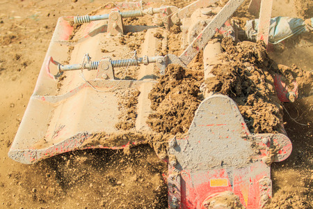 Tractor plows a field shoveling