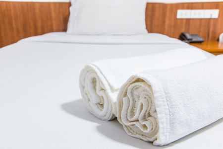 White bed and towels on the bedの写真素材