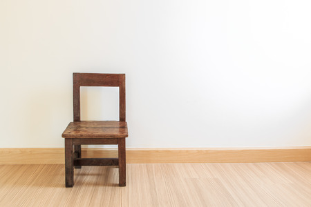 Old wooden chair on laminate flooring in the roomの写真素材