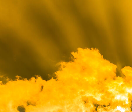 Rays of light shining through dark clouds for backgroundの写真素材