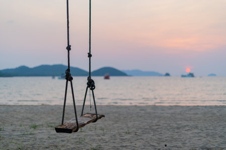 Sunset view with swing at the beach of Koh Mak, Trat Province, Thailandの写真素材