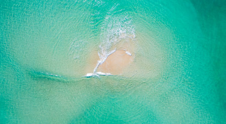 waves crashing on sandy beach