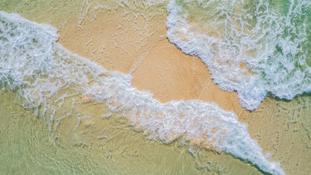 waves crashing on sandy beachの写真素材