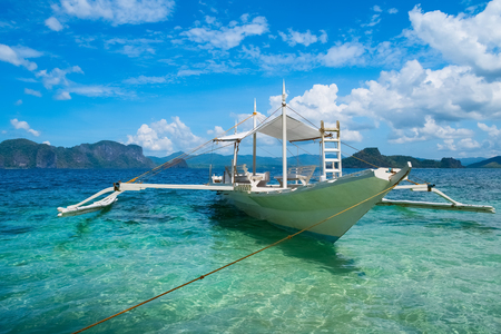 Traditional wooden boat in clear sea water, El Nido, Palawan, Philippinesの写真素材