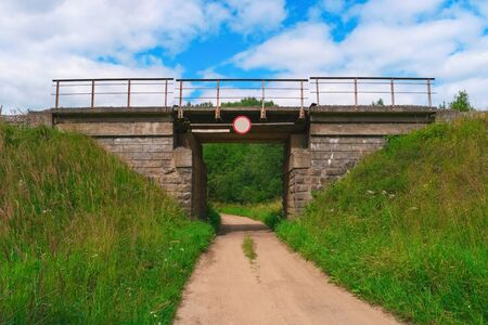 Railway bridge over a rural gravel road