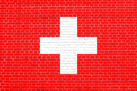 Flag of Switzerland on brick wall texture background. Swiss national flag.の写真素材