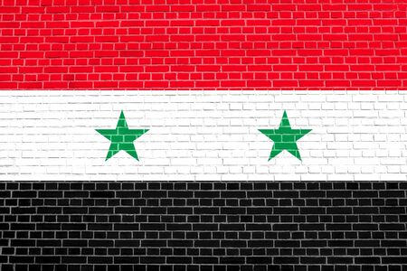 Flag of Syria on brick wall texture background. Syrian national flag.の写真素材