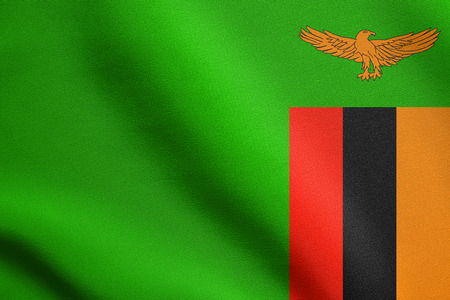 Zambian national official flag. African patriotic symbol, banner, element, background. Accurate dimensions. Correct size, colors. Flag of Zambia waving in the wind with detailed fabric textureの写真素材