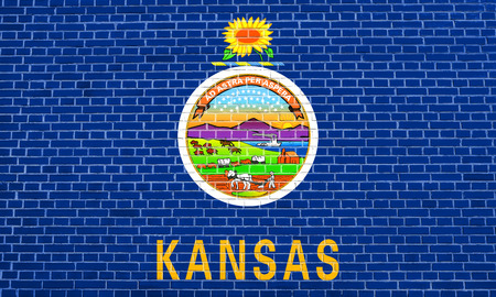 Kansan official flag, symbol. American patriotic element. USA banner. United States of America background. Flag of the US state of Kansas on brick wall texture backgroundの写真素材