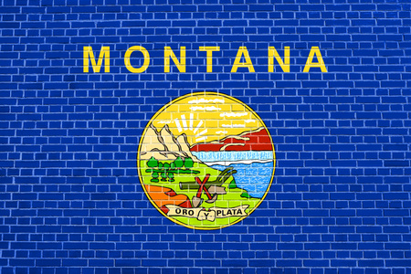 Montanan official flag, symbol. American patriotic element. USA banner. United States of America background. Flag of the US state of Montana on brick wall texture backgroundの写真素材