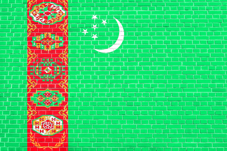Turkmen national official flag. Patriotic symbol, banner, element, background. Accurate dimensions. Correct size, colors. Flag of Turkmenistan on brick wall texture backgroundの写真素材