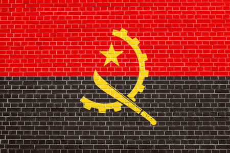 Angolan national official flag. African patriotic symbol, banner, element, background. Flag of Angola on brick wall texture backgroundの写真素材