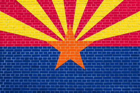 Arizonian official flag, symbol. American patriotic element. USA banner. United States of America background. Flag of the US state of Arizona on brick wall texture backgroundの写真素材