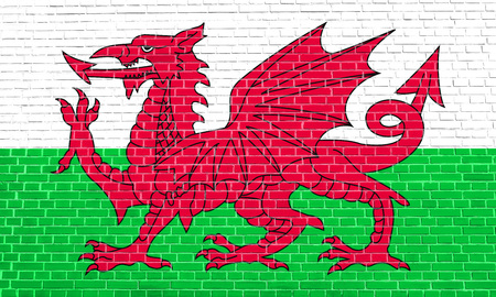 Welsh national official flag. Patriotic symbol, banner, element, background. Flag of Wales on brick wall texture backgroundの写真素材