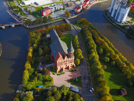 Aerial cityscape of Kaliningrad, Russia. Gothic cathedral in Kaliningrad city, formerly Koenigsberg, Germany. Beautiful view of Kant Island. The center of city in autumn. Birds eye panoramaの写真素材