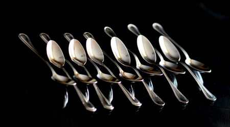 Lot a teaspoons on a black backgroundの写真素材